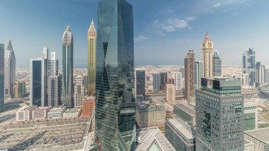 Panorama showing many futuristic skyscrapers in financial district business center in Dubai on Sheikh Zayed road . Aerial view from above with clouds
