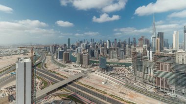 Panorama showing skyline of Dubai with business bay and downtown district . Aerial view of many modern skyscrapers with cloudy blue sky. United Arab Emirates.