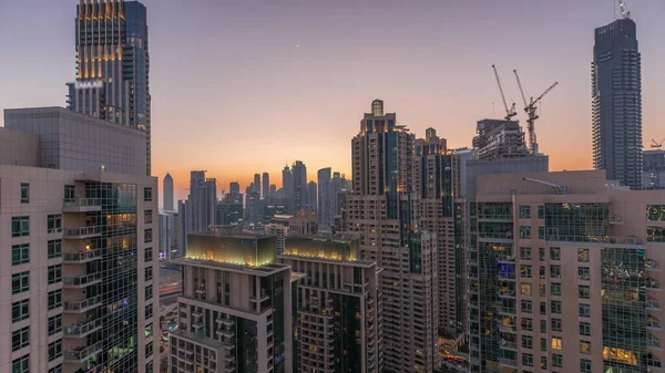 stock image Dubai skyscrapers with golden sky over business bay district day to night transition . Aerial view from of downtown in United Arab Emirates.