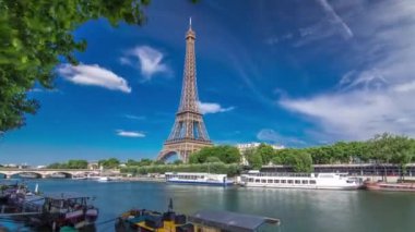 Paris 'teki Seine nehrinin rıhtımından Eyfel Kulesi' nin zaman ayarlı hiperhızlandırması. Güneşli yaz gününde nehirde gemi ve tekneler
