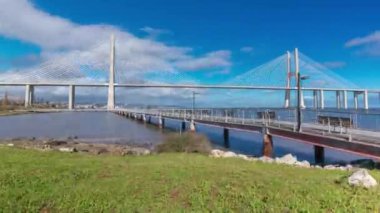 The Vasco da Gama Bridge timelapse hyperlapse with pier. Cable-stayed longest bridge flanked by viaducts and rangeviews that spans the Tagus River in Park of Nations in Lisbon, Portugal
