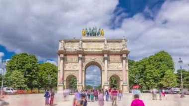 Triumphal Arc de Triomphe du Atlıkarınca zaman atlaması Paris, Fransa 'daki Tuileries bahçelerinde yüksek hızda. Yaz günü mavi bulutlu gökyüzüyle gezen bir turist. Yürürken