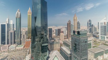 Panorama showing many futuristic skyscrapers in financial district business center in Dubai on Sheikh Zayed road . Aerial view from above with clouds