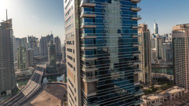 Panorama showing Dubai Marina and JBR area and the famous Ferris Wheel aerial  and golden sand beaches in the Persian Gulf during sunrise