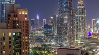 Aerial view of Dubai International Financial Centre district skyscrapers day to night transition  from downtown. Office towers from glass and hotels with modern buildings