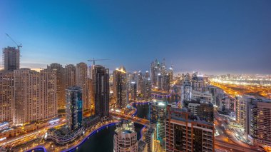 Dubai Marina hava sahasının en uzun bloğundaki çeşitli gökdelenlerin panoramasını suni kanalla gece gündüz geçişi. Günbatımından sonra JBR bölgesinde birçok kule ve yat var.