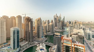 Panorama showing various skyscrapers in tallest recidential block in Dubai Marina aerial  with artificial canal. Many towers and yachts