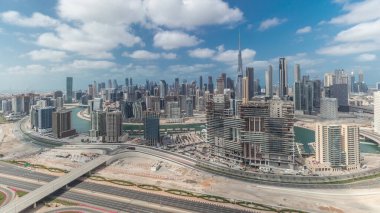 Panorama showing skyline of Dubai downtown district with business bay . Aerial view of many modern skyscrapers with cloudy blue sky. United Arab Emirates.