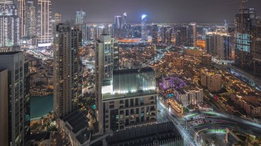 Panorama showing aerial view of a big futuristic city night . Business bay and Downtown district with many skyscrapers and traditional houses, Dubai, United Arab Emirates skyline.