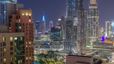 Aerial view of Dubai International Financial Centre district skyscrapers day to night transition  from downtown. Office towers from glass and hotels with modern buildings