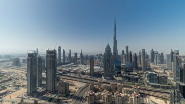 Panorama showing aerial view of tallest towers in Dubai Downtown skyline and highway . Financial district and business area in smart urban city. Skyscraper and high-rise buildings