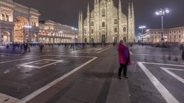 Panorama showing Milan Cathedral and historic buildings night timelapse. Duomo di Milano is the cathedral church located at the Piazza del Duomo square in Milan city in Italy