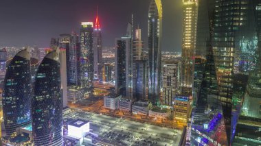 Dubai 'nin finans merkezi. Lüks gökdelenler, gece gündüz geçiş zamanları, Dubai, Birleşik Arap Emirlikleri. Otoparkı ve çatısı olan hava manzarası