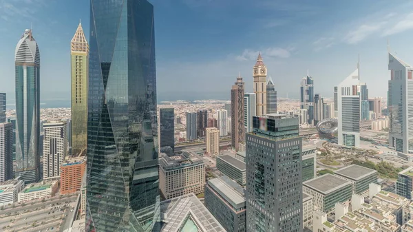 stock image Panorama showing many futuristic skyscrapers in financial district business center in Dubai on Sheikh Zayed road timelapse. Aerial view from above with clouds