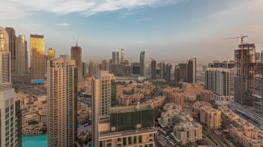 Panorama showing aerial panoramic skyline of a big futuristic city during sunset . Business bay and Downtown district with skyscrapers and traditional houses, Dubai, United Arab Emirates