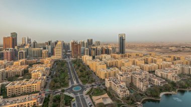 Panorama showing skyscrapers in Barsha Heights district and low rise buildings in Greens district aerial . Dubai skyline with palms and trees