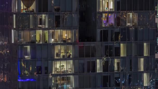시간에 빛나는 창문들이 아파트 건물의 전경을 수있다 주거용 유리창을 공중에서 — 비디오