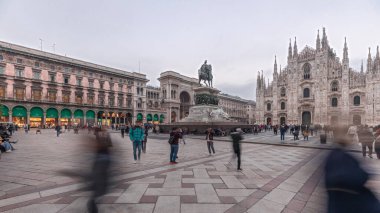 Panorama showing Milan Cathedral and historic buildings day to night transition timelapse. Duomo di Milano is the cathedral church located at the Piazza del Duomo square in Milan city in Italy