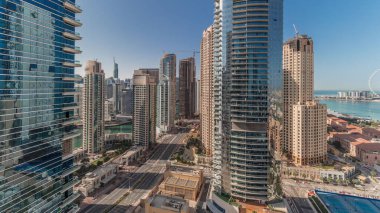 Panorama showing Dubai Marina and JBR area and the famous Ferris Wheel aerial and golden sand beaches in the Persian Gulf at the morning