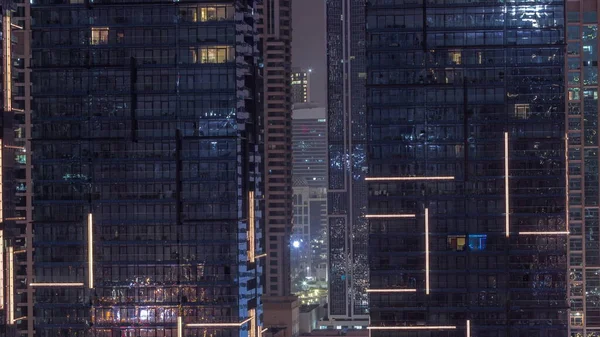 stock image Flat night panorama of multicolor blinking light in windows of multistory buildings aerial. Illuminated skyscraper in a big city