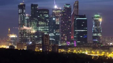 Skyscrapers International Business Center City at night from Sparrow hills day to night transition timelapse, Moscow, Russia. View from above to illuminated towers