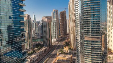 Panorama showing Dubai Marina and JBR area and the famous Ferris Wheel aerial and golden sand beaches in the Persian Gulf during sunrise