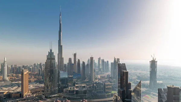 stock image Aerial view of tallest towers in Dubai Downtown skyline and highway during all day. Skyscraper and high-rise buildings with shadows moving fast