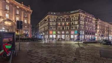 Panorama showing the Cordusio Square night timelapse. Illuminated historic buildings, monument and tram traffic. One of squares in the center of the city at the crossroads of six old streets.