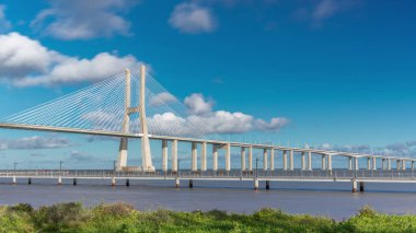The Vasco da Gama Bridge timelapse hyperlapse. Cable-stayed longest bridge flanked by viaducts and rangeviews that spans the Tagus River in Park of Nations in Lisbon, the capital of Portugal