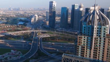 Aerial top view of busy traffic on Dubai highway urban and modern transportration concept. Cars driving on junction and overpass in Dubai Marina