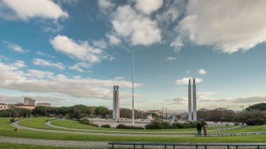 Miradouro Park Eduardo VII timelapse hyperlapse in Lisbon, Portugal, Europe. Looking towards gardens in the park with Marquess of Pombal Statue and Avenida de Liberdade in a background on cloudy day.