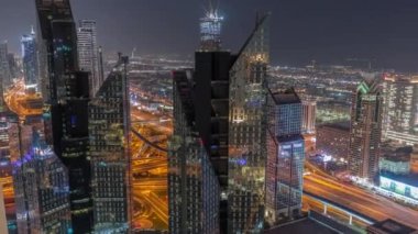 Dubai 'deki Sheikh Zayed Yolu' ndaki yüksek binalar gece uçuşları, BAE. Uluslararası finans bölgesindeki gökdelenler. Şehir yürüyüş evleri ve arka planda büyük kavşak