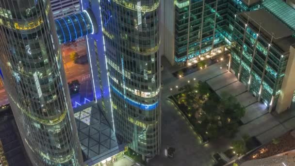 ドバイの空中夜間のタイムラプス アラブ首長国連邦のシェイク ザイド ロードの高層ビルの景色を見下ろします 上から国際金融センターの輝く窓のある照明付き高層ビル — ストック動画