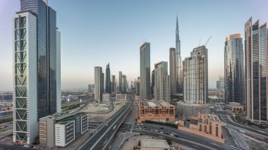 Dubai şehir merkezinin havadan panoramik görüntüsü. Günbekten geceye geçiş zamanına kadar pek çok kule var. Akıllı şehir şehrindeki iş alanı. Günbatımından sonra gökdelen ve yüksek binalar, BAE.