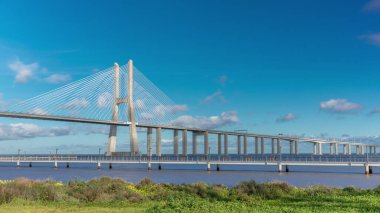 The Vasco da Gama Bridge timelapse hyperlapse. Cable-stayed longest bridge flanked by viaducts and rangeviews that spans the Tagus River in Park of Nations in Lisbon, the capital of Portugal