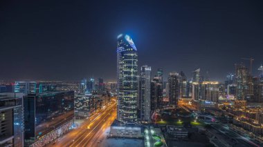 Panorama, Dubai Şehir Merkezi ve Business Bay gece zaman çizelgesini gösteriyor. Dubai 'deki en yüksek gökdelen ve diğer aydınlık kuleler, Birleşik Arap Emirlikleri manzaralı..