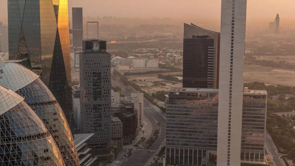 stock image Skyline view of the high-rise buildings around highway road in Dubai aerial timelapse during sunrise, UAE. Skyscrapers in International Financial Centre from above early morning