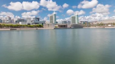 Portekiz, Lizbon 'daki Parque das Nacoes ya da Milletler Parkı' nı gösteren panorama. Telekabin teleferikleri Tagus nehri üzerindeki Vasco da Gama köprüsüne bakıyor. Modern binalar suya yansıyor