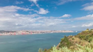 Lizbon şehir manzarası ve Tagus Nehri zaman çizelgesini gösteren panorama, Almada 'daki Cristo Rei' nin bakış açısından tarihi 25 Nisan köprüsü ile Eski Şehir Alfama 'nın hava manzarası. Portekiz