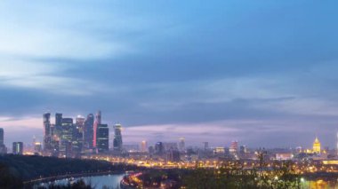 Panoramic view of Moscow City, Russia, from Sparrow Hills day to night transition timelapse from above. Cloudy colorful sky over skyscrapers