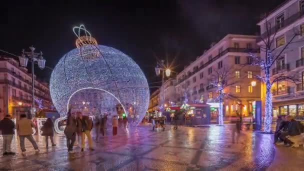 パノラマは ルイス カモエス広場プラカ ルイス カモエスの夜のタイムラプスで大きなボールでクリスマスの装飾を示しています ポルトガルのリスボン市で最大の広場の一つは 夕方に照らされました — ストック動画