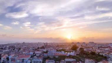 Panoramic aerial view over Rooftops of Portos old town on a warm spring evening timelapse during sunset time with cloudy colorful sky, Porto, Portugal