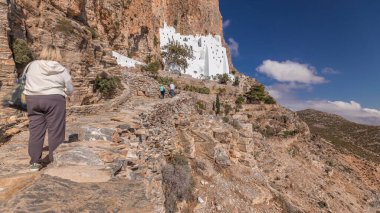 Panorama showing the famous white Hozoviotissa Monastery standing on a rock over the Aegean sea in Amorgos island timelapse hyperlapse, Cyclades, Greece.