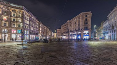 Panorama showing the Cordusio Square night timelapse. Illuminated historic buildings, monument and tram traffic. One of squares in the center of the city at the crossroads of six old streets.