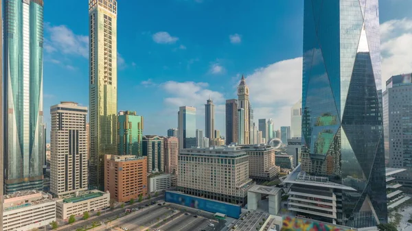 Sunrise in Dubai International Financial district transition timelapse. Panoramic aerial view of business office towers at morning. Skyscrapers with hotels and shopping malls near downtown