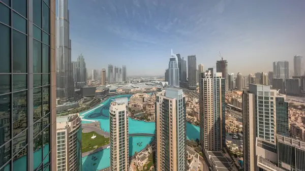 Dubai downtown during sunrise with fountains and modern futuristic architecture aerial timelapse. Panoramic view to skyscrapers with old town and shopping mall