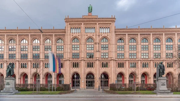 Building of the district government of Upper Bavaria (Regierung von Oberbayern) timelapse. Front view with monuments and flags. Traffic on the road. Munich, Germany