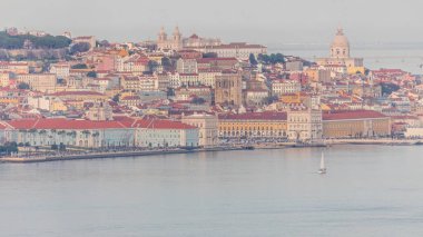 Portekiz 'in Lizbon şehrinde Pantheon ve Comercio Meydanı' nın (Praca do Comercio) renkli turuncu çatıları görülüyor. Gün batımında Cristo Rei perspektifinden üst görünüm