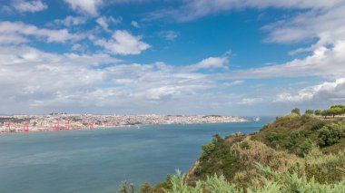 Lizbon şehir manzarası ve Tagus Nehri zaman çizelgesini gösteren panorama, Almada 'daki Cristo Rei' nin bakış açısından tarihi 25 Nisan köprüsü ile Eski Şehir Alfama 'nın hava manzarası. Portekiz