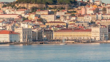 The Commercial Square with crowd aerial timelapse, Castle Hill and Alfama district of Lisbon, Portugal viewed from Almada over Tagus river. Historic buildings with warm sunset light. Yachts floating clipart